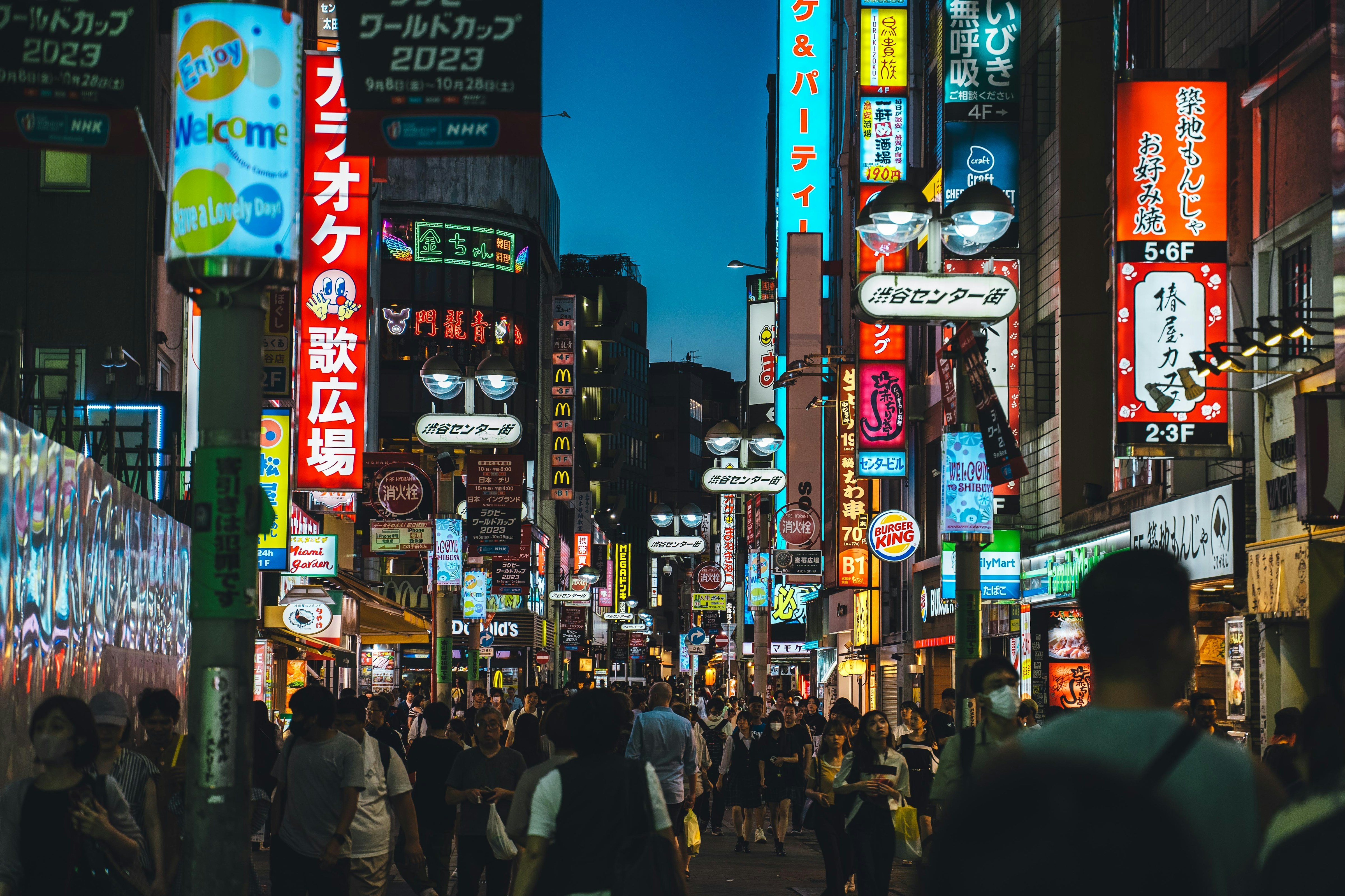 Busy Tokyo street at night with bright billboards